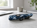 Navy Blue Rose Floral MagSafe Loop iPhone Case shown in a neutral white professional lifestyle setting