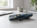 Navy Gold Marble MagSafe Loop iPhone Case shown in a neutral white professional lifestyle setting