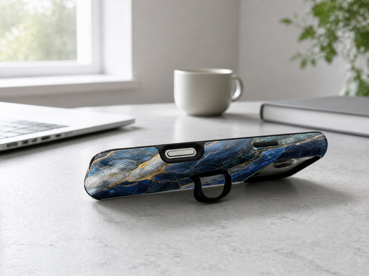 Navy Gold Marble MagSafe Loop iPhone Case shown in a neutral white professional lifestyle setting