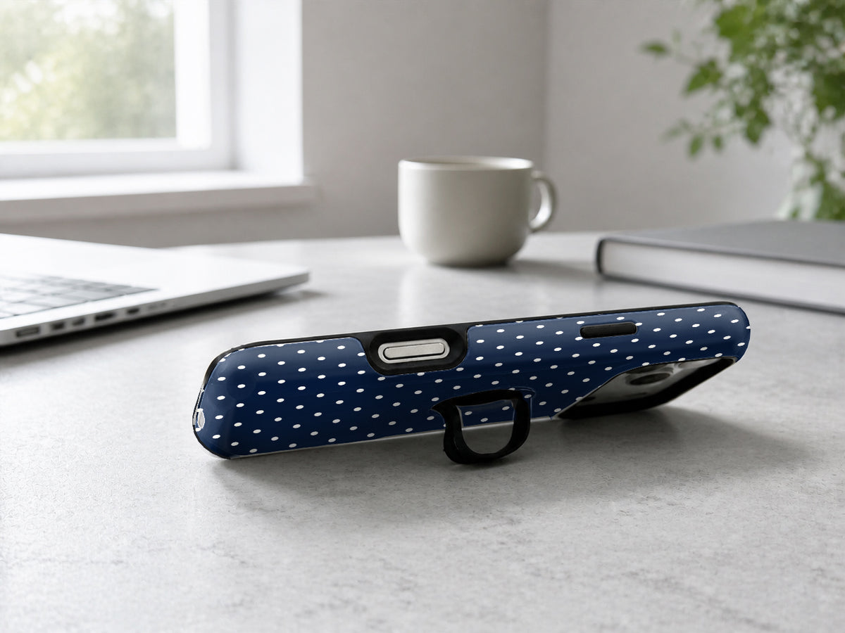 Navy Mini Polka Dot MagSafe Loop iPhone Case shown in a neutral white professional lifestyle setting