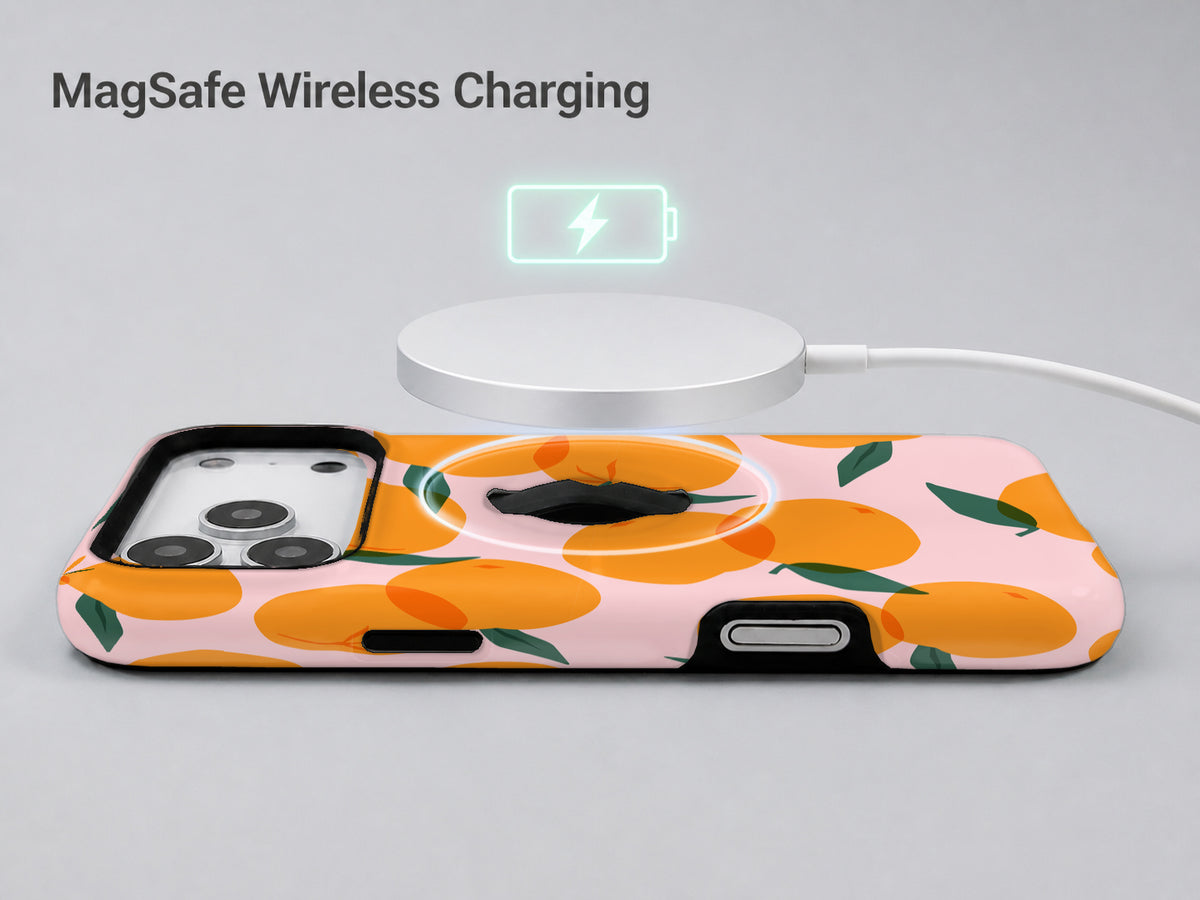Orange Fruit on Pink MagSafe Loop iPhone Case shown with a MagSafe-compatible wireless charger attached