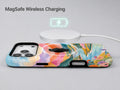 Pastel Painted Meadow Landscape MagSafe Loop iPhone Case shown with a MagSafe-compatible wireless charger attached