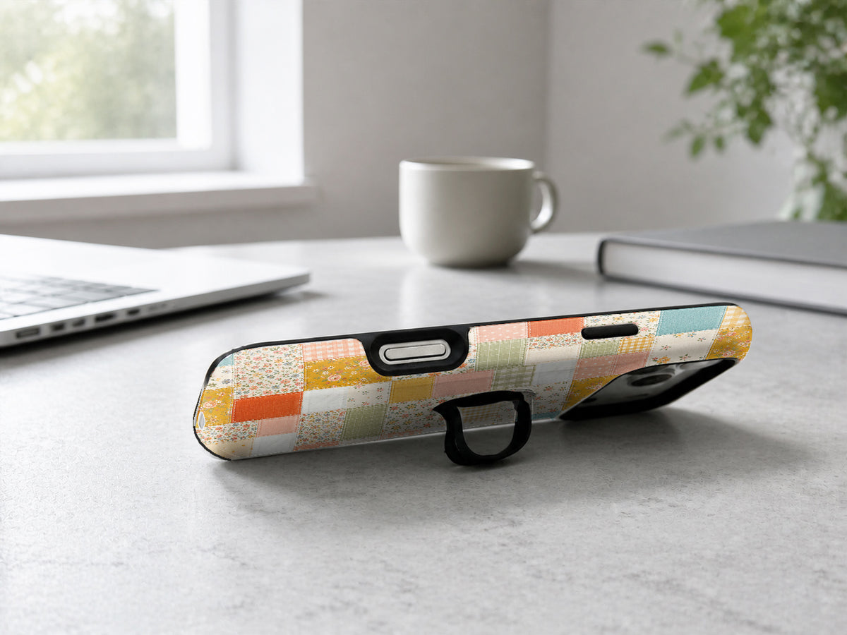 Pastel Quilt Patchwork MagSafe Loop iPhone Case shown in a neutral white professional lifestyle setting