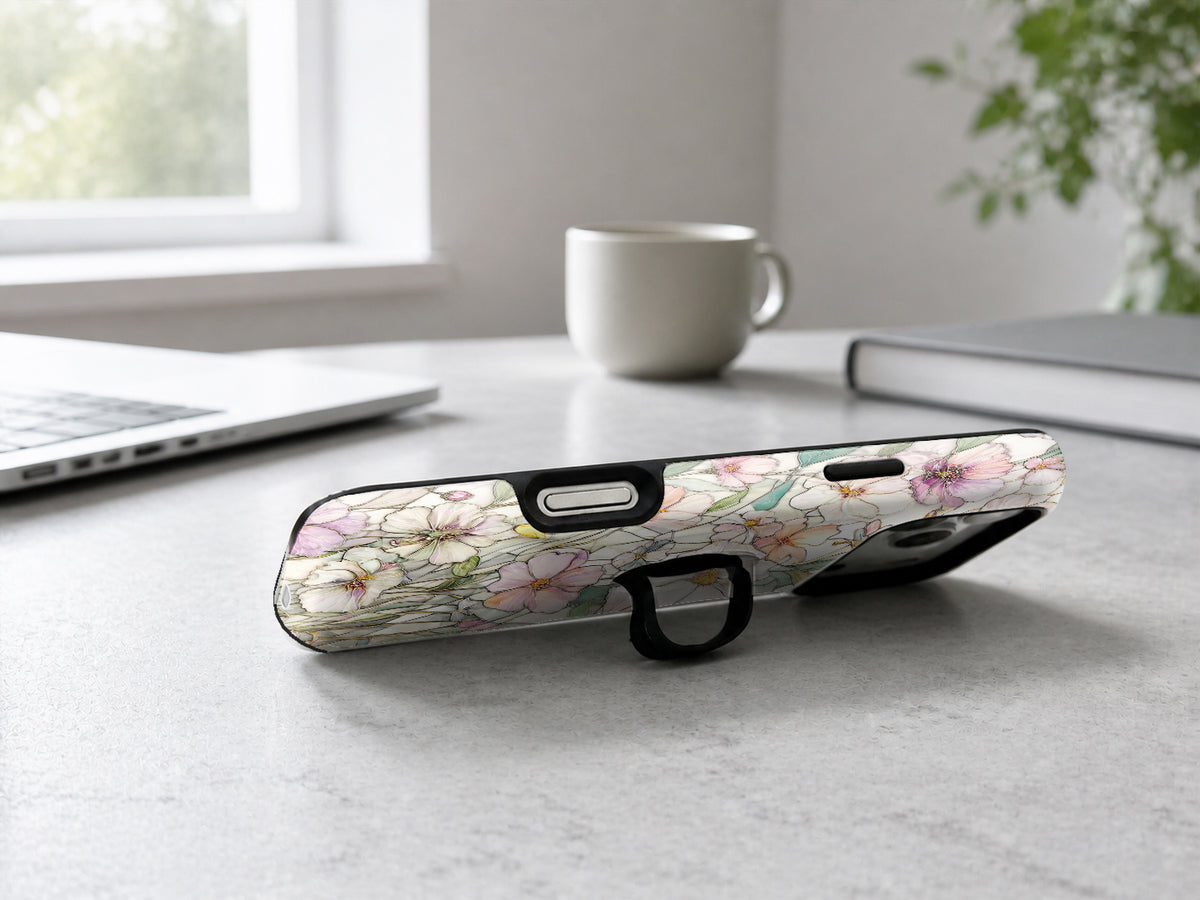 Pastel Wildflower Stained Glass MagSafe Loop iPhone Case shown in a neutral white professional lifestyle setting