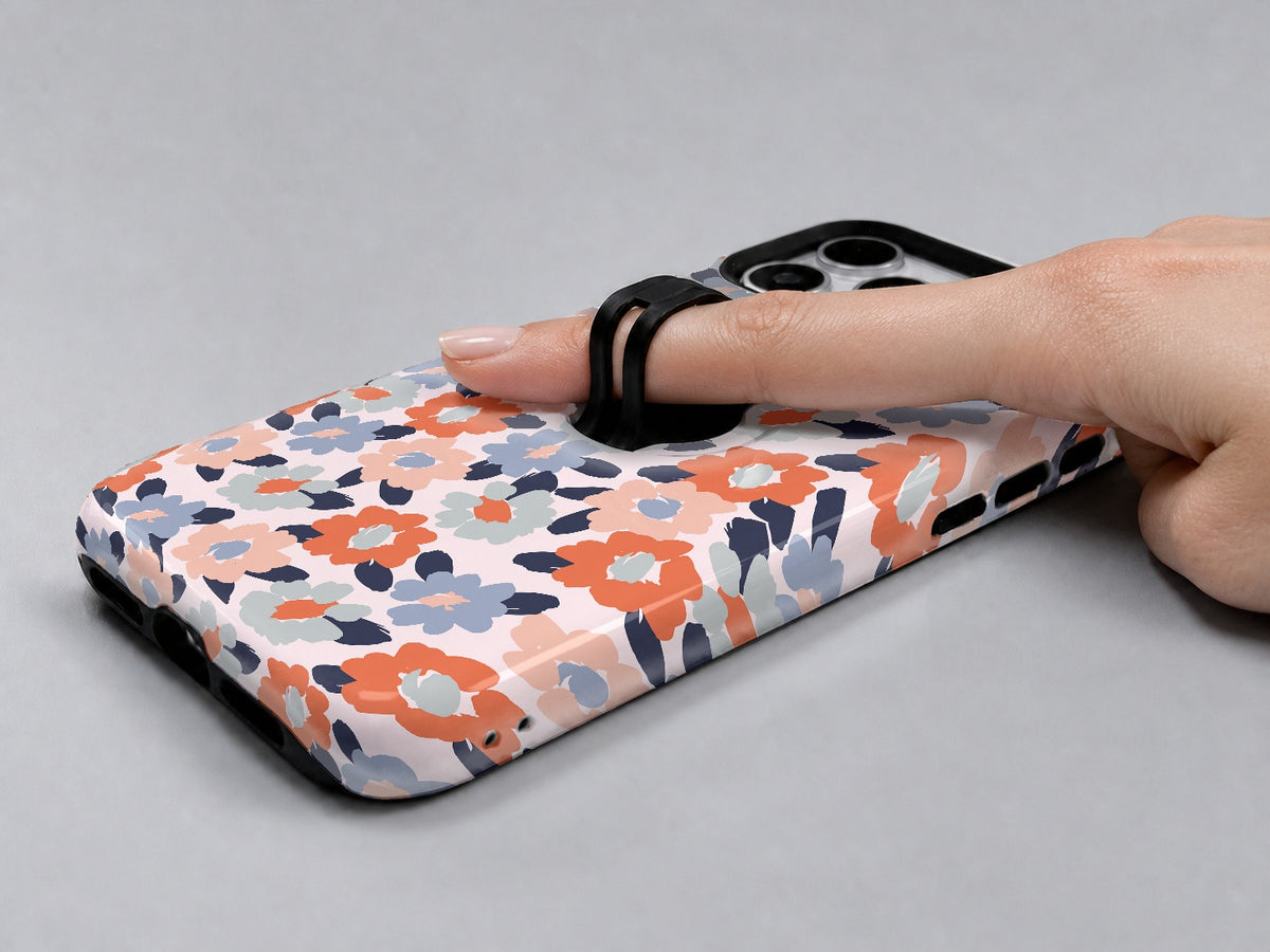 Peach Blue Abstract Leopard MagSafe Loop iPhone Case shown in use with a finger through the horizontal loop