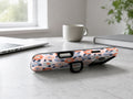 Peach Blue Abstract Leopard MagSafe Loop iPhone Case shown in a neutral white professional lifestyle setting