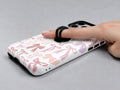 Pink Coquette Bow Toile MagSafe Loop iPhone Case shown in use with a finger through the horizontal loop