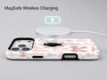 Pink Coquette Bow Toile MagSafe Loop iPhone Case shown with a MagSafe-compatible wireless charger attached