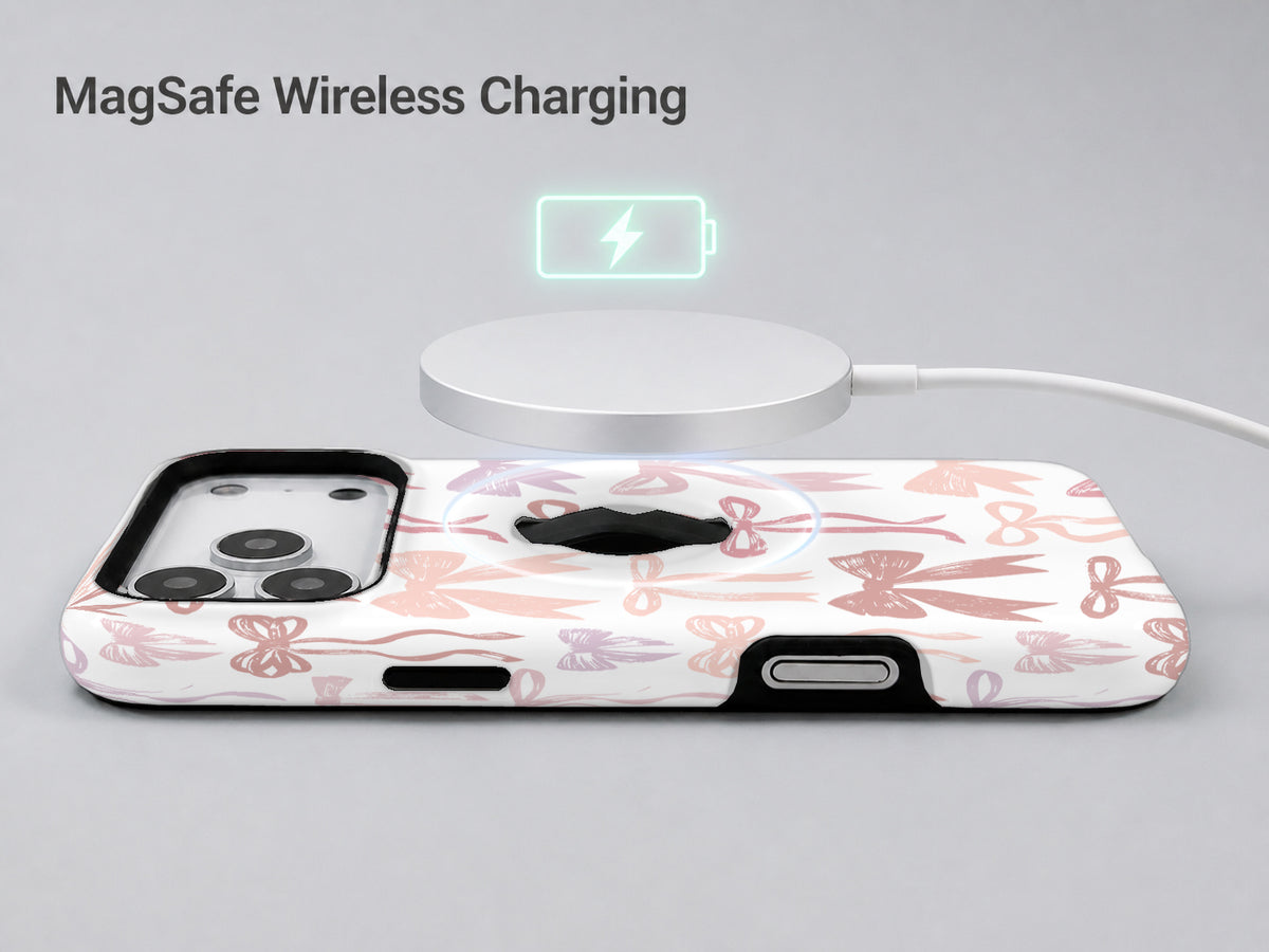 Pink Coquette Bow Toile MagSafe Loop iPhone Case shown with a MagSafe-compatible wireless charger attached