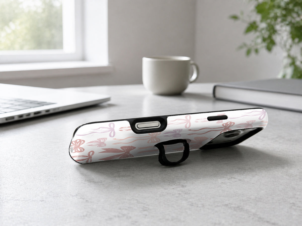 Pink Coquette Bow Toile MagSafe Loop iPhone Case shown in a neutral white professional lifestyle setting