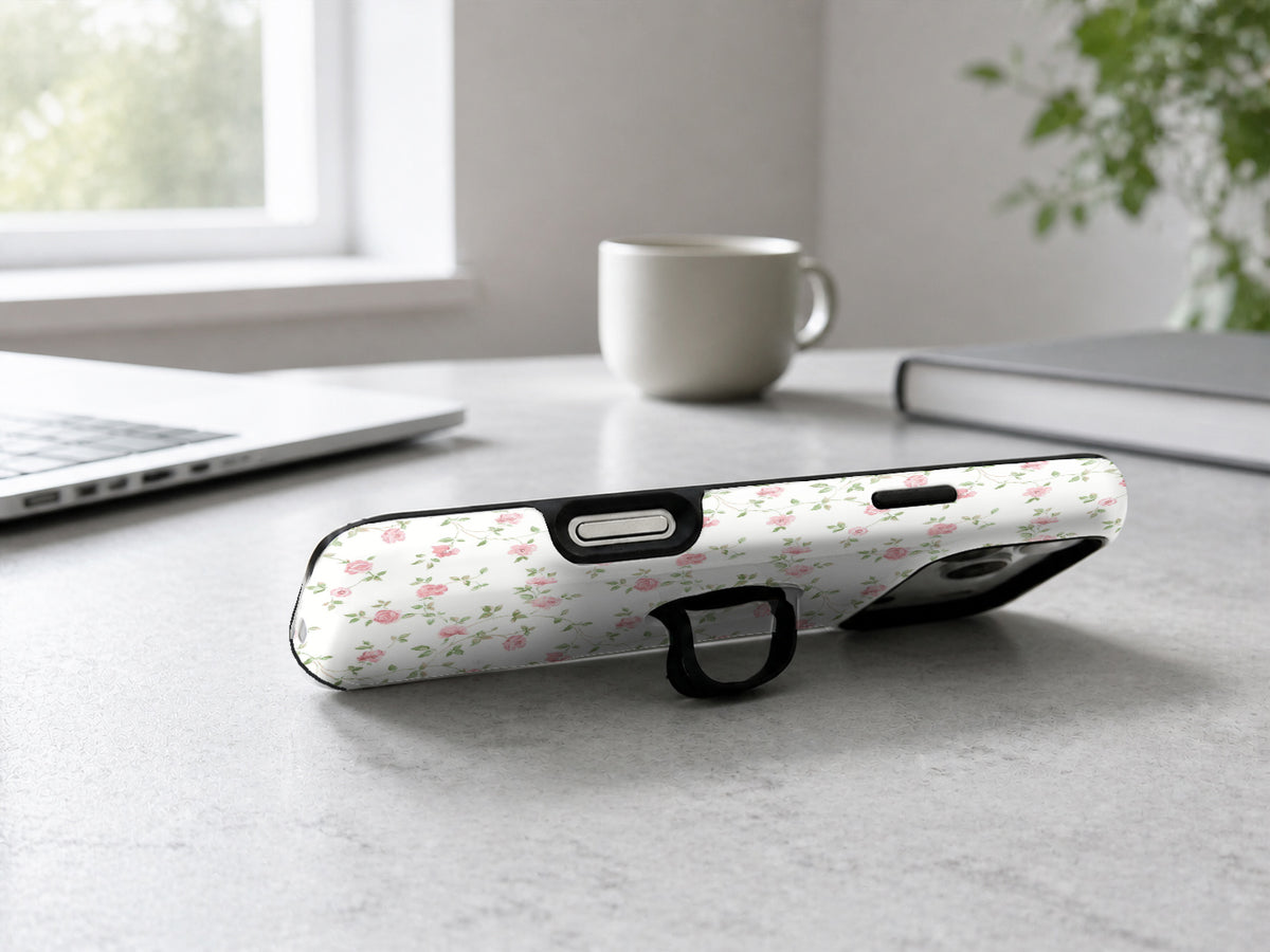 Pink Ditsy Floral MagSafe Loop iPhone Case shown in a neutral white professional lifestyle setting