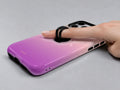 Pink Purple Ombre Gradient MagSafe Loop iPhone Case shown in use with a finger through the horizontal loop