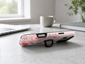 Pink Retro Doodle Floral MagSafe Loop iPhone Case shown in a neutral white professional lifestyle setting