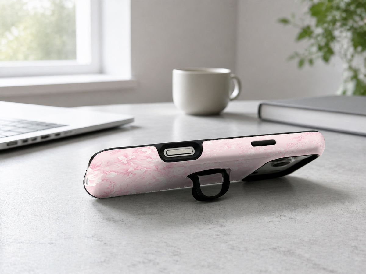 Pink Toile Floral MagSafe Loop iPhone Case shown in a neutral white professional lifestyle setting