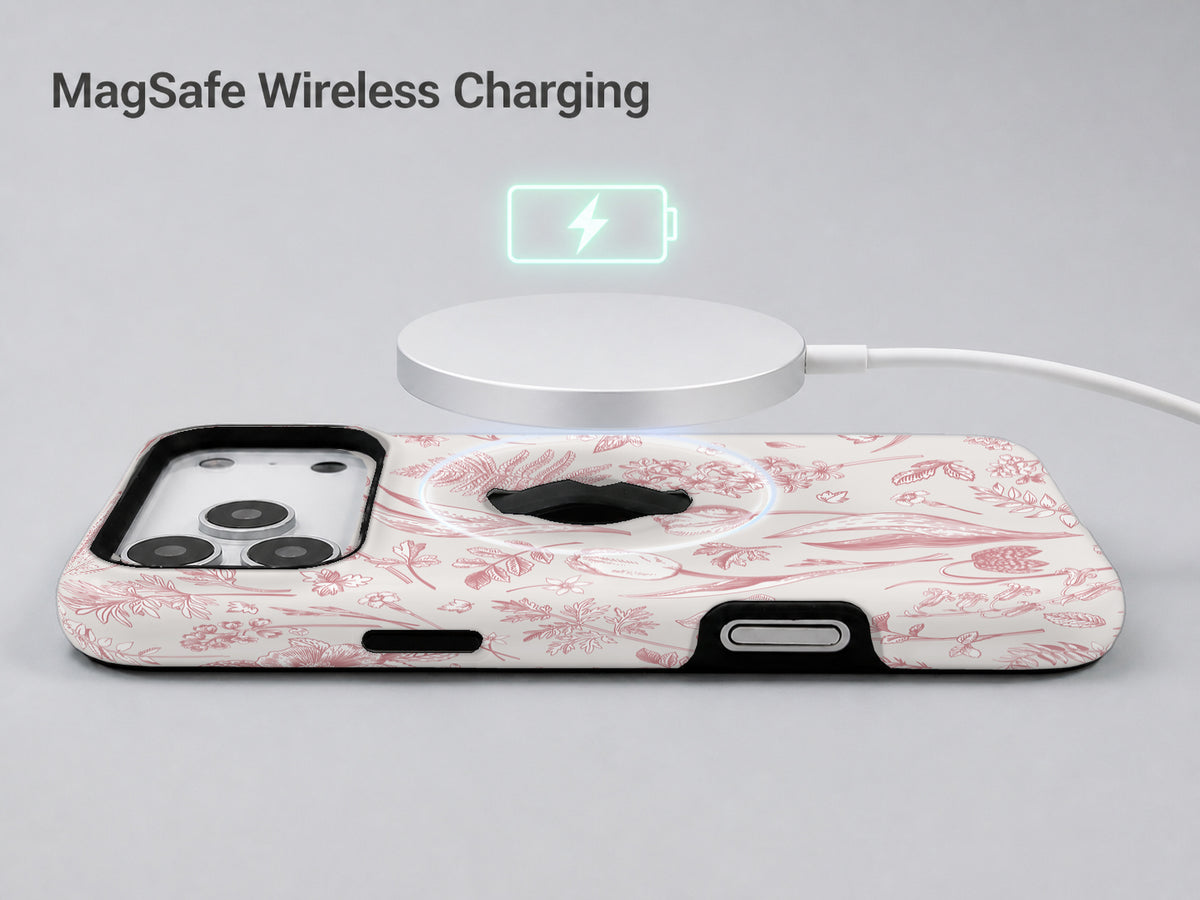 Pink Toile Wildflower MagSafe Loop iPhone Case shown with a MagSafe-compatible wireless charger attached