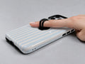 Powder Blue Pinstripe MagSafe Loop iPhone Case shown in use with a finger through the horizontal loop