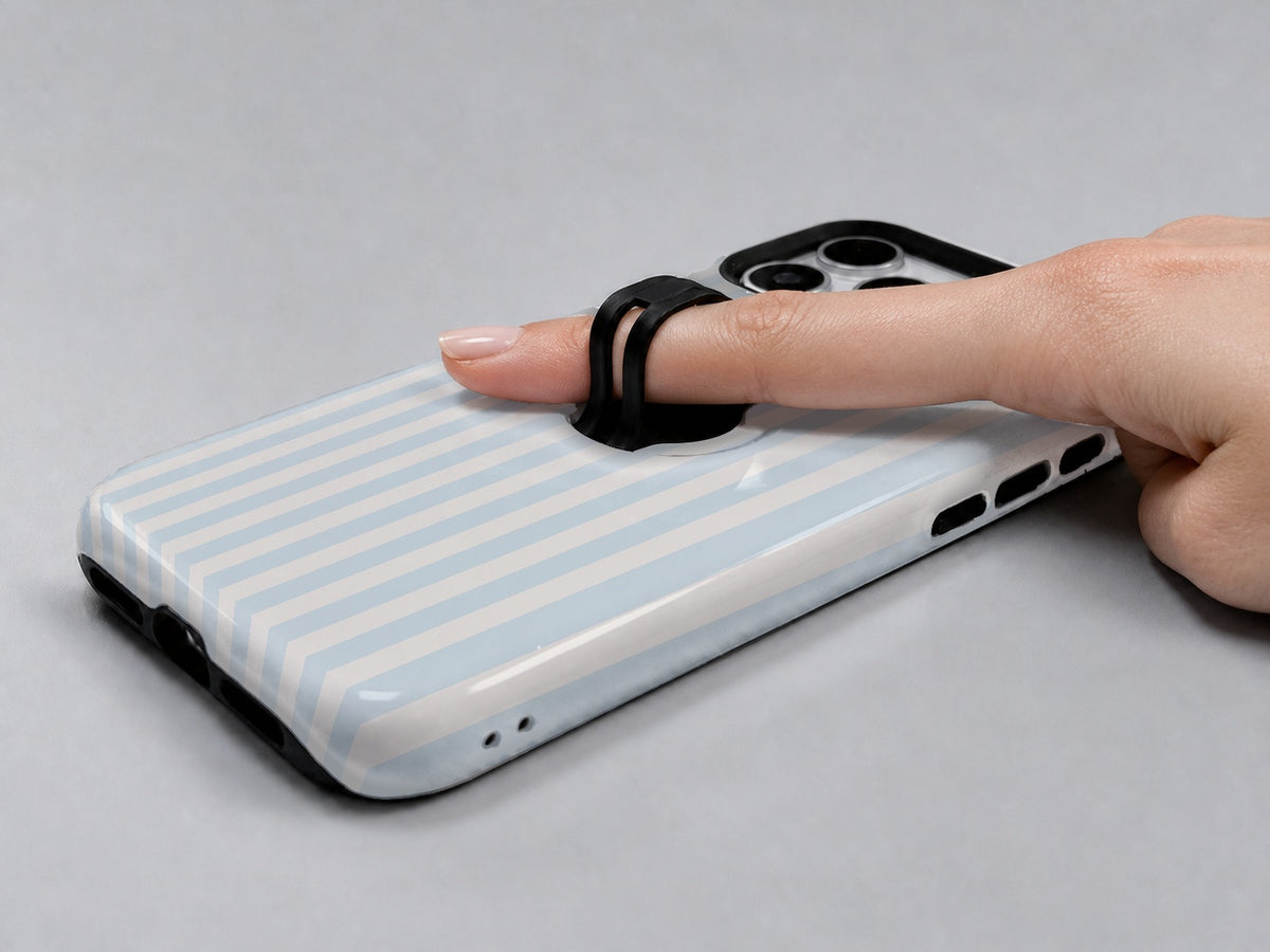 Powder Blue Pinstripe MagSafe Loop iPhone Case shown in use with a finger through the horizontal loop