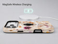 Pressed Wildflower Bouquet MagSafe Loop iPhone Case shown with a MagSafe-compatible wireless charger attached
