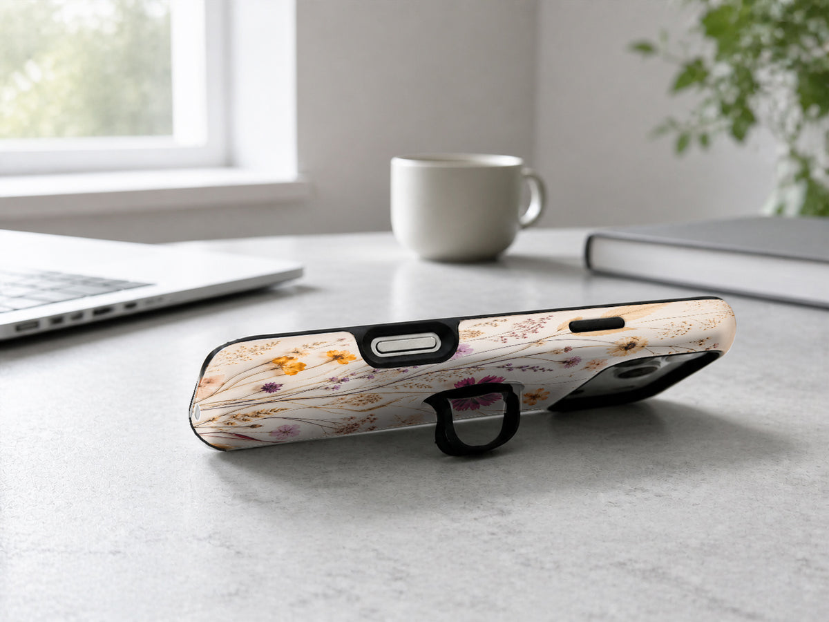 Pressed Wildflower Bouquet MagSafe Loop iPhone Case shown in a neutral white professional lifestyle setting