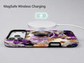Purple Pressed Flower Garden MagSafe Loop iPhone Case shown with a MagSafe-compatible wireless charger attached