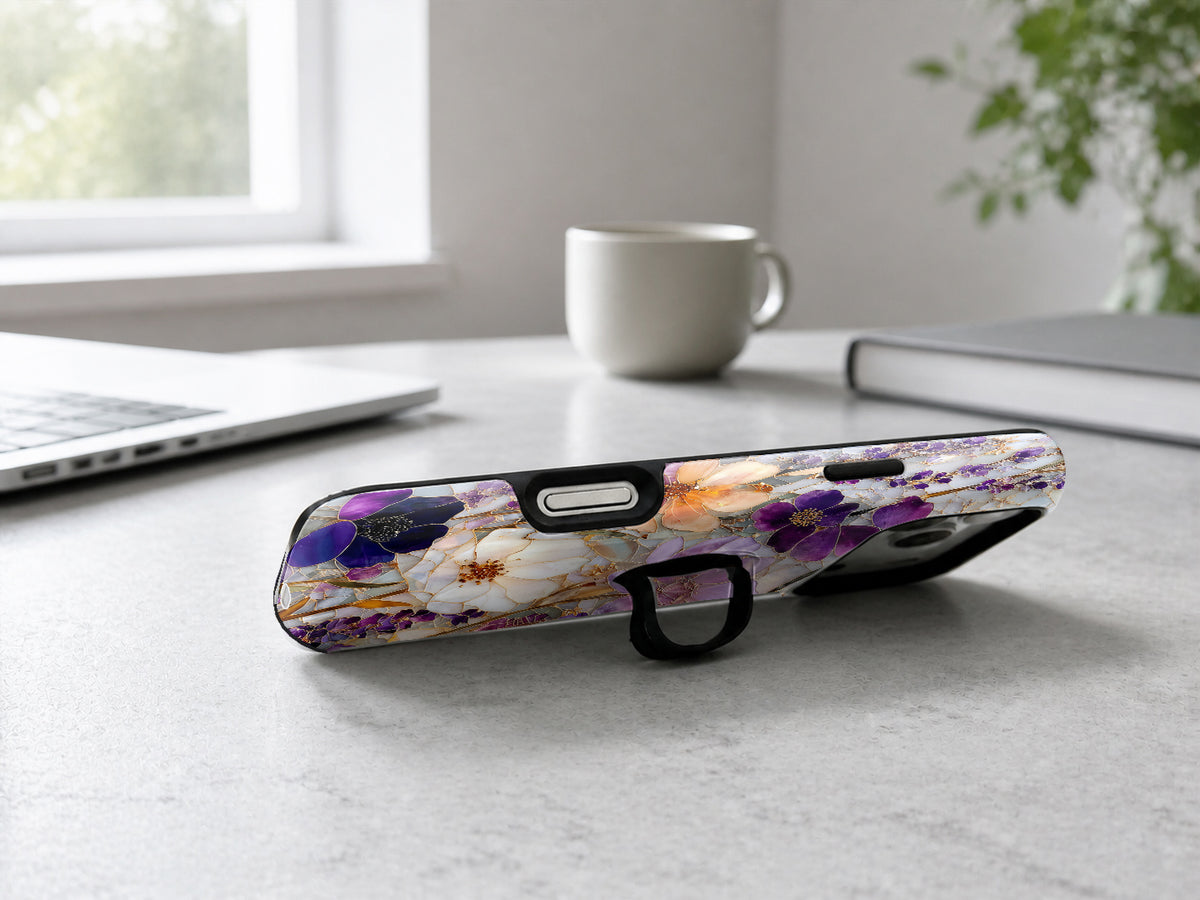 Purple Pressed Flower Garden MagSafe Loop iPhone Case shown in a neutral white professional lifestyle setting