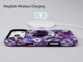Purple Watercolor Flower Field MagSafe Loop iPhone Case shown with a MagSafe-compatible wireless charger attached