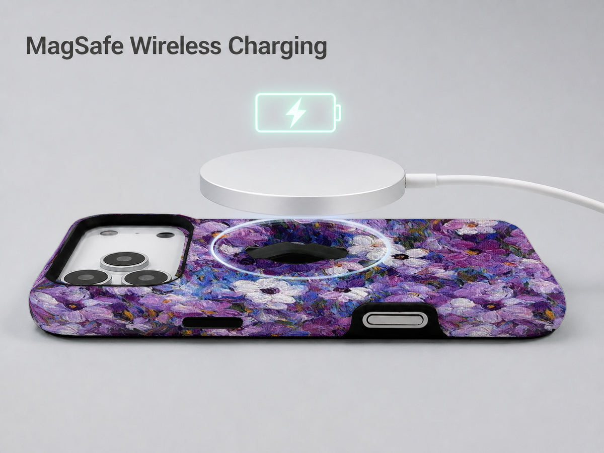Purple Watercolor Flower Field MagSafe Loop iPhone Case shown with a MagSafe-compatible wireless charger attached