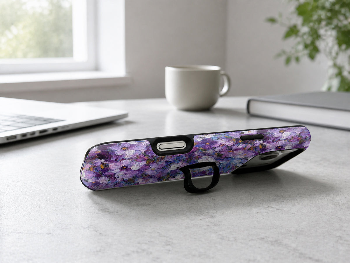 Purple Watercolor Flower Field MagSafe Loop iPhone Case shown in a neutral white professional lifestyle setting