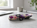 Purple Wildflower Glass Garden MagSafe Loop iPhone Case shown in a neutral white professional lifestyle setting