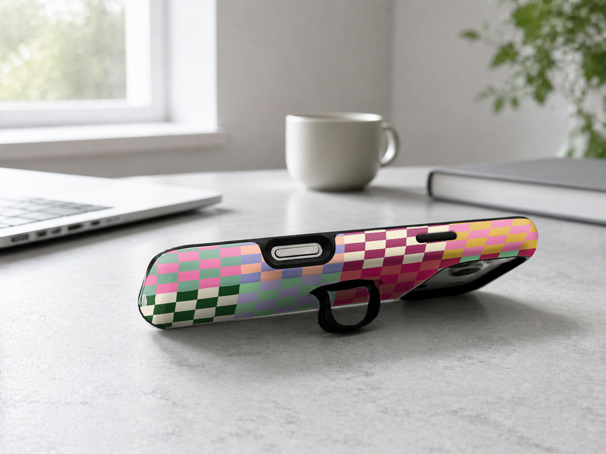 Rainbow Checkerboard Patchwork MagSafe Loop iPhone Case shown in a neutral white professional lifestyle setting