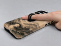Red Sun Mountain Bridge MagSafe Loop iPhone Case shown in use with a finger through the horizontal loop