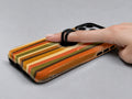 Retro Sunset Stripe MagSafe Loop iPhone Case shown in use with a finger through the horizontal loop