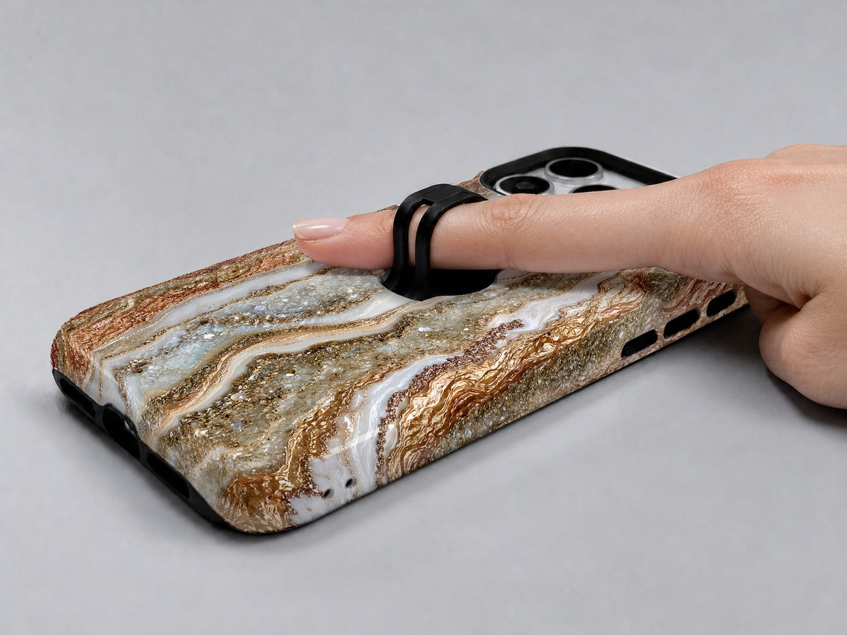 Rose Gold Agate Marble MagSafe Loop iPhone Case shown in use with a finger through the horizontal loop