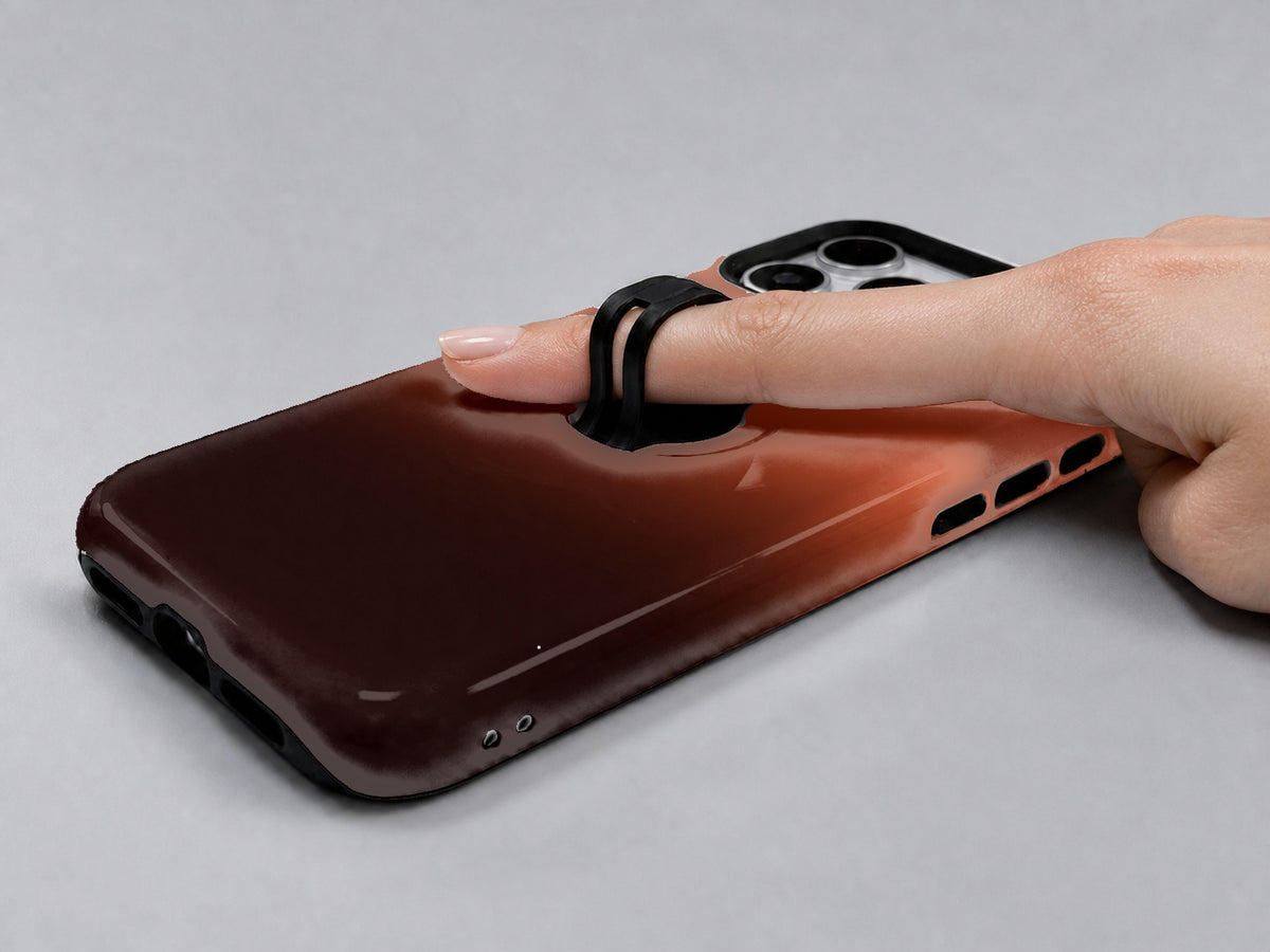Rust Brown Ombre Gradient MagSafe Loop iPhone Case shown in use with a finger through the horizontal loop