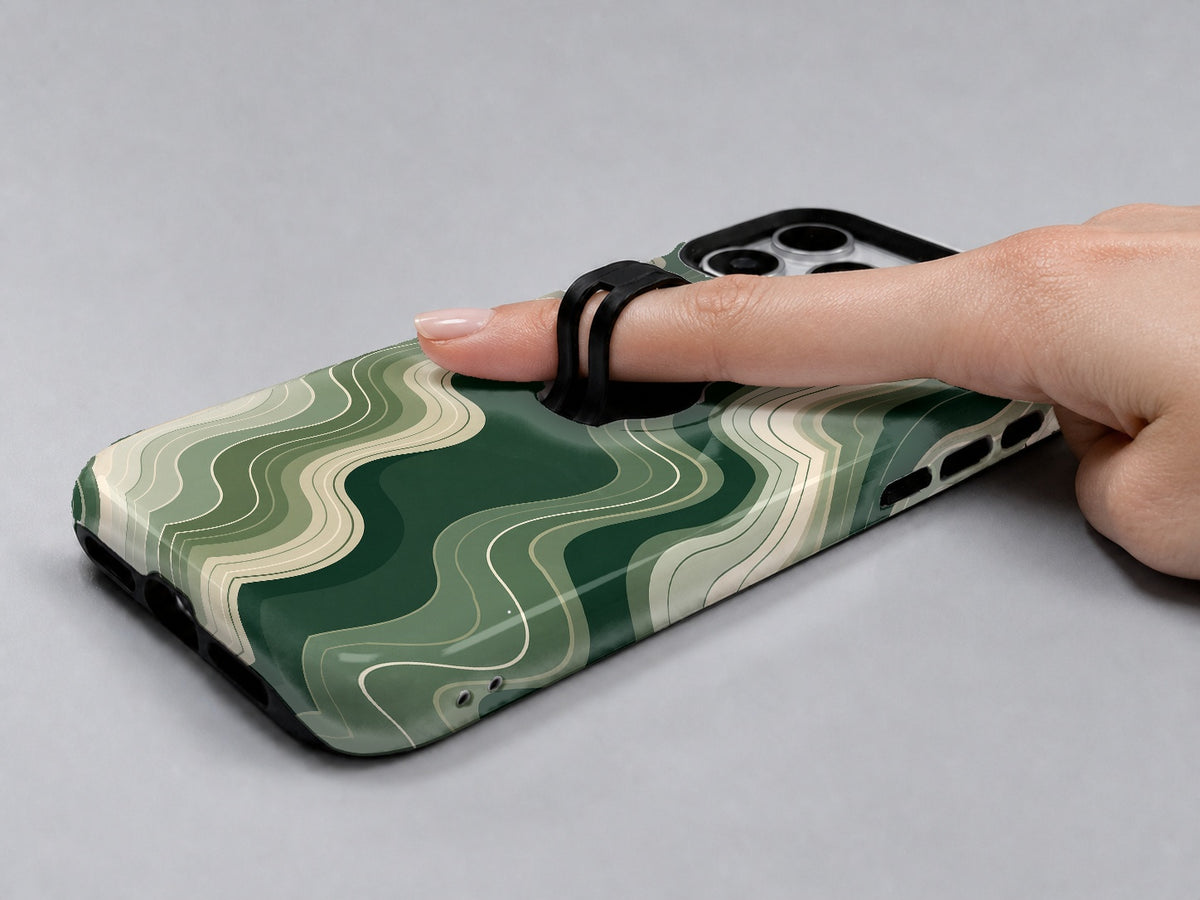 Sage Green Layered Waves MagSafe Loop iPhone Case shown in use with a finger through the horizontal loop