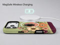 Sage Retro Folk Floral MagSafe Loop iPhone Case shown with a MagSafe-compatible wireless charger attached