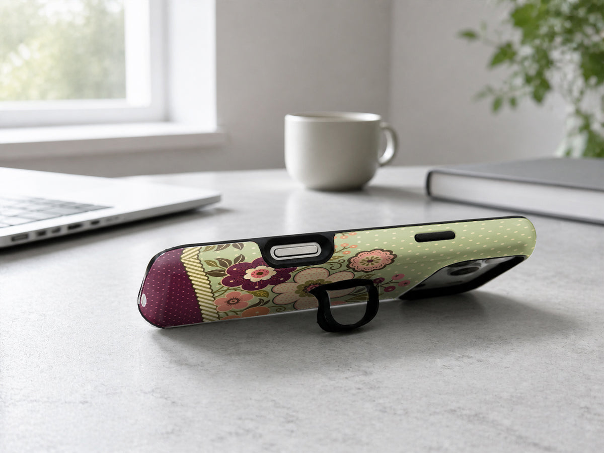 Sage Retro Folk Floral MagSafe Loop iPhone Case shown in a neutral white professional lifestyle setting