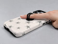 Silver Puffy Star MagSafe Loop iPhone Case shown in use with a finger through the horizontal loop