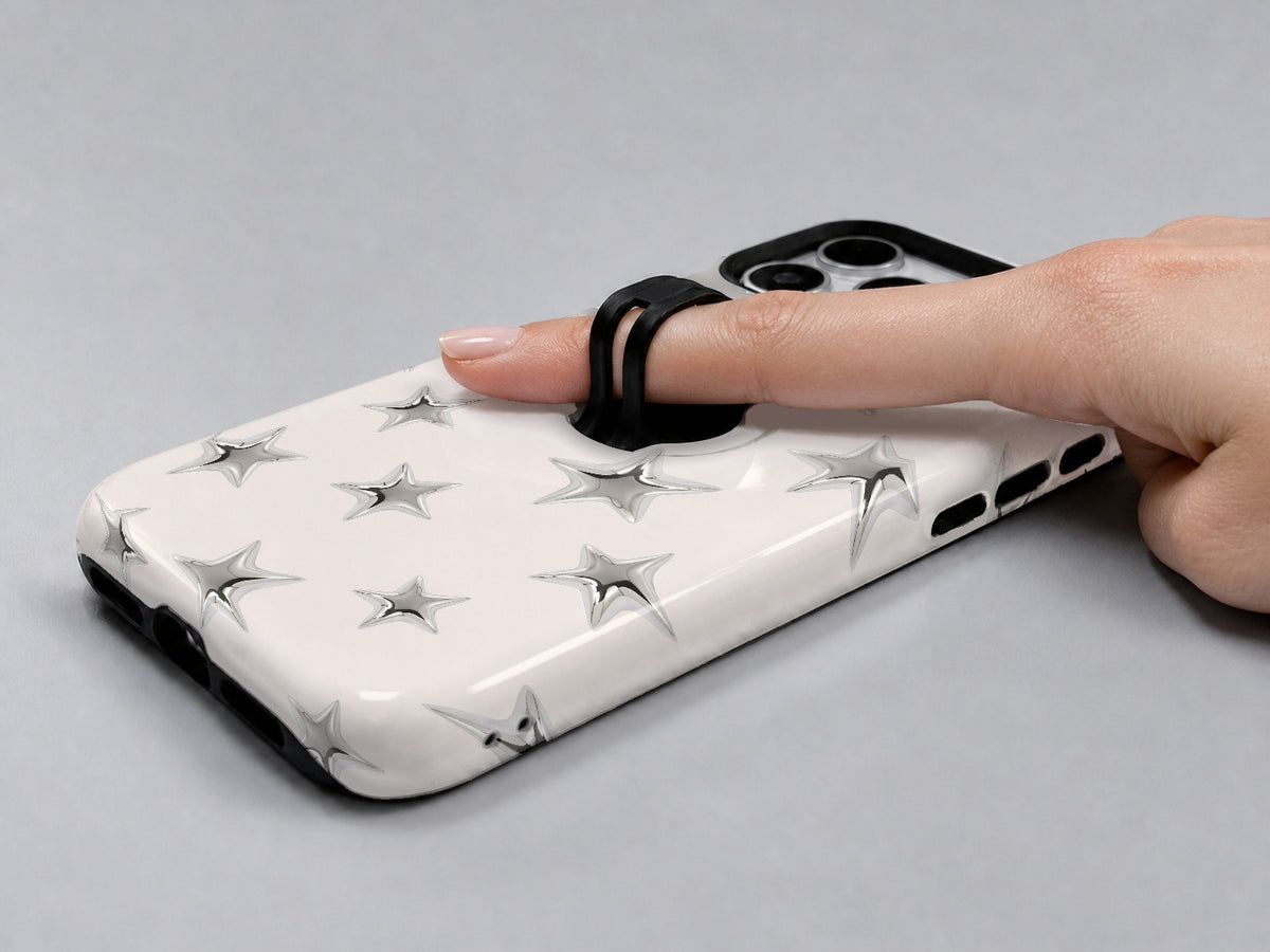 Silver Puffy Star MagSafe Loop iPhone Case shown in use with a finger through the horizontal loop