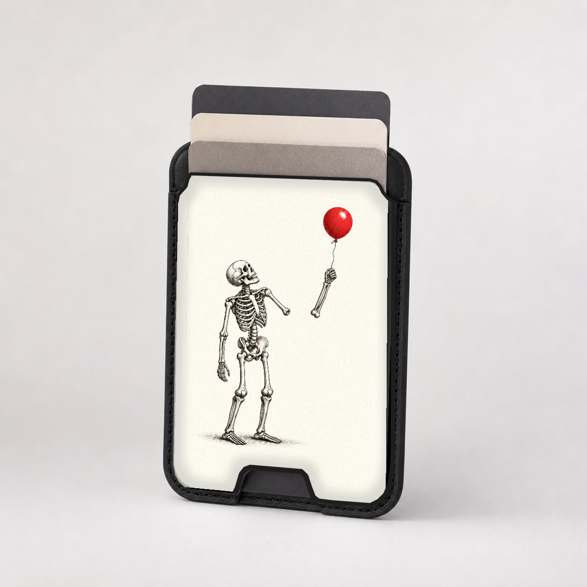 Skeleton with Red Balloon MagSafe Card Holder, card storage shown with cards