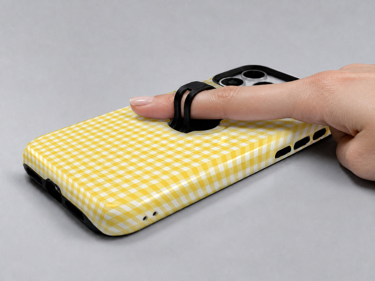 Sunflower Yellow and White Gingham MagSafe Loop Case, shown with a finger through the loop