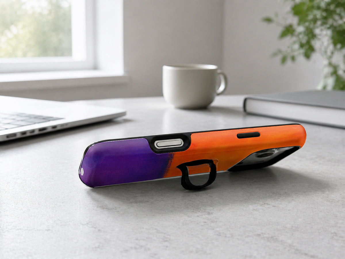 Tangerine Purple Color Block MagSafe Loop iPhone Case shown in a neutral white professional lifestyle setting