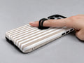 Taupe Pinstripe MagSafe Loop iPhone Case shown in use with a finger through the horizontal loop
