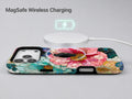 Teal Pink Stained Glass Floral MagSafe Loop iPhone Case shown with a MagSafe-compatible wireless charger attached