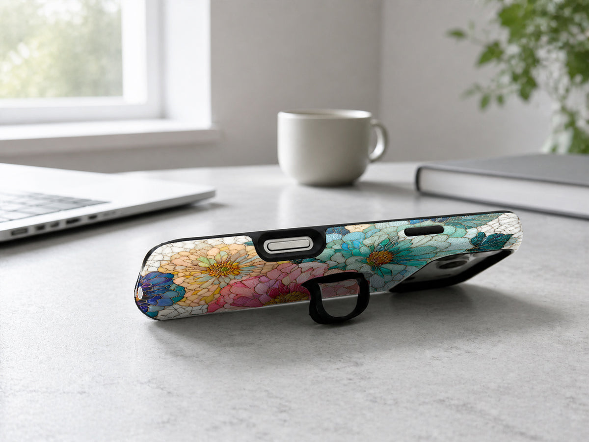 Teal Pink Stained Glass Floral MagSafe Loop iPhone Case shown in a neutral white professional lifestyle setting