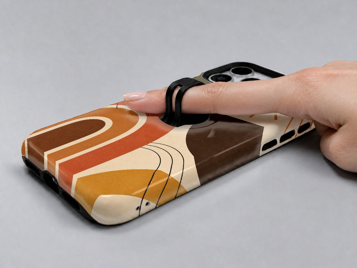 Terracotta Boho Arch MagSafe Loop iPhone Case shown in use with a finger through the horizontal loop