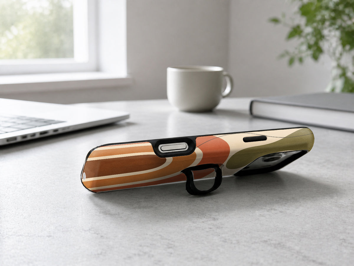 Terracotta Boho Arch MagSafe Loop iPhone Case shown in a neutral white professional lifestyle setting