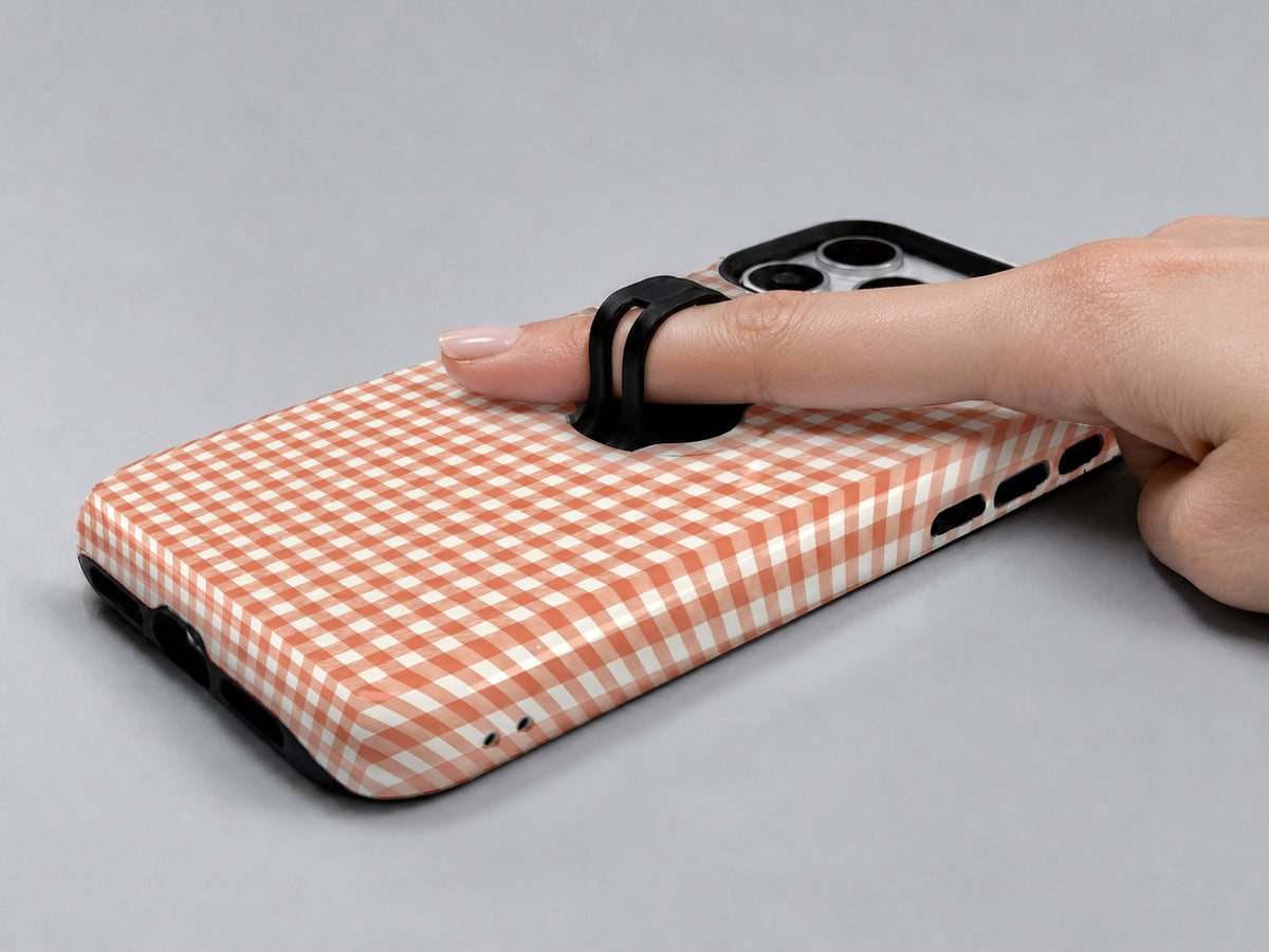 Terracotta Orange and White Gingham MagSafe Loop Case, shown with a finger through the loop