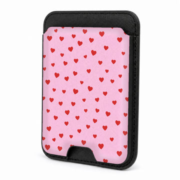 Front view of the Tiny Red Hearts MagSafe card holder on a white background