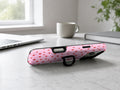 Tiny Red Hearts MagSafe Loop iPhone Case shown in a neutral white professional lifestyle setting